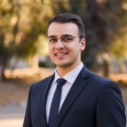 Portrait of Matthew Mayer, smiling in a navy suit
